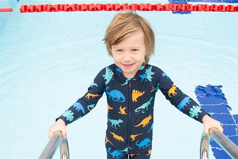 Boy standing next to the pool